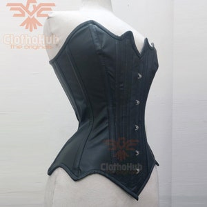 May include: A black leather corset with a sweetheart neckline and a busk closure. The corset has a smooth, shiny finish and is accented with silver-toned metal eyelets and hooks.