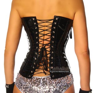 May include: A black, glossy corset with a lace-up back, paired with silver sequin shorts. The outfit includes a black choker and fingerless gloves. The corset has a shiny finish and is a form-fitting garment.