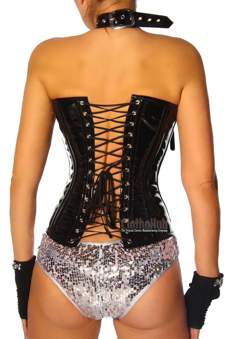 May include: A black, glossy corset with a lace-up back, paired with silver sequin shorts. The outfit includes a black choker and fingerless gloves. The corset has a shiny finish and is a form-fitting garment.