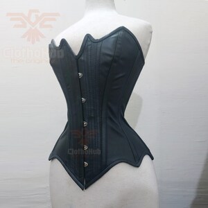 May include: A black leather corset with a sweetheart neckline and a pointed bottom. The corset has a busk closure in the front and is made of a smooth, shiny material.
