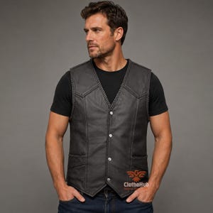 May include: A black leather waistcoat featuring a braided trim along the V-neckline and pocket edges, four silver-tone snap buttons down the front, and two lower pockets. The waistcoat is worn over a plain black t-shirt, with the ClothoHub logo visible.