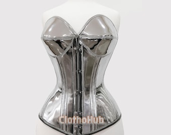 May include: A silver, glossy corset with a sweetheart neckline and a structured silhouette. The corset features a series of buttons down the front and is displayed on a mannequin. The text "Clothohub" is visible at the bottom.