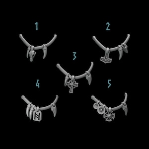 May include: Five different necklaces with various pendants, including a skull, a hammer, a cross, a rune, and a circle with a symbol. Each necklace is made of a silver-colored metal and has a set of three small, pointed teeth on each side.