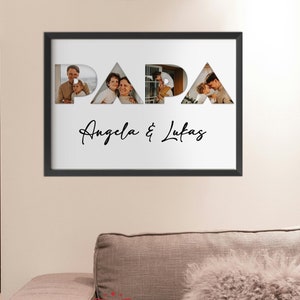 May include: A black framed photo with a white background featuring the word "PAPA" in large letters with photos of a family inside each letter. The text "Angela & Lukas" is written below the word "PAPA".