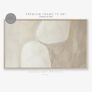 May include: Abstract art print featuring a beige background with three white organic shapes. The print is framed in a light wood frame.