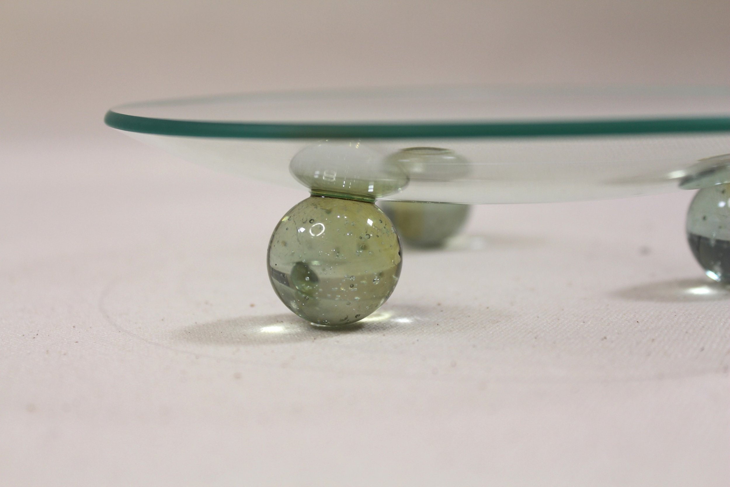 Vintage Glass Tray Elevated On Light Green Marbles