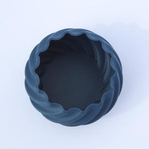 Top view of a 3D printed navy blue plant pot, photographed on a white background.