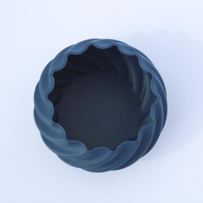 Top view of a 3D printed navy blue plant pot, photographed on a white background.