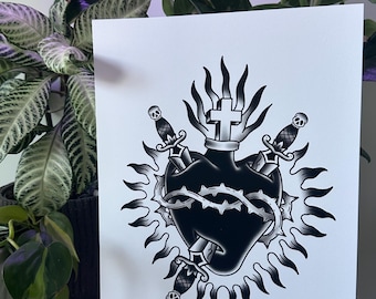 May include: Black and white tattoo art print featuring a heart pierced by three daggers, encircled by a crown of thorns and a sunburst design. A cross sits atop the heart. The artist's name, @tvptattoos, is printed at the bottom.
