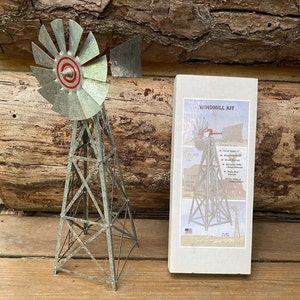 May include: A metal windmill kit with a galvanized steel tower and blades. The kit includes instructions and all necessary hardware. The windmill is 17 inches tall and is designed for outdoor use.