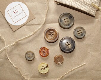 8 different four-hole buttons in brown tones, jacket buttons