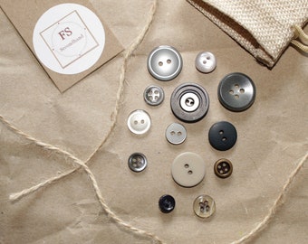 13 dark buttons, two- and four-hole buttons, sewing material