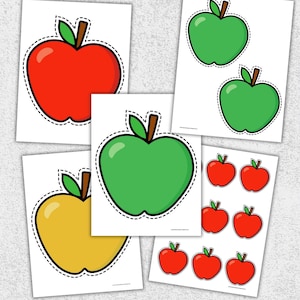 May include: Assortment of apple-shaped stickers in red, green, and yellow. Each sticker has a black outline and a brown stem with green leaves. The stickers are on white paper.