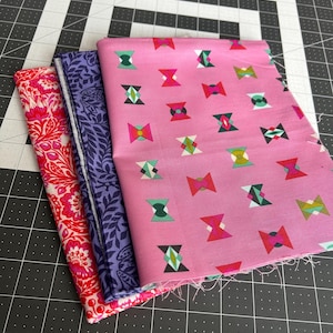 May include: A white ceramic mug with a black handle and the text "But First, Coffee" in a black, bold font. The mug is on a white surface.