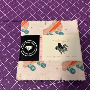 May include: A white ceramic mug with a black handle and the text "But First, Coffee" in a black, handwritten-style font. The mug is on a white surface.