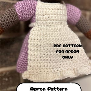 May include: Crocheted apron pattern in white with a ruffled hem, paired with a lilac dress. The text on the image reads "PDF PATTERN FOR APRON ONLY" and "Apron Pattern Chez Yarn Cafe Collection".