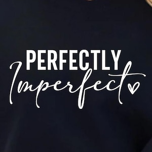 May include: Black cropped sweatshirt with the text "PERFECTLY Imperfect" in white with a small heart symbol.