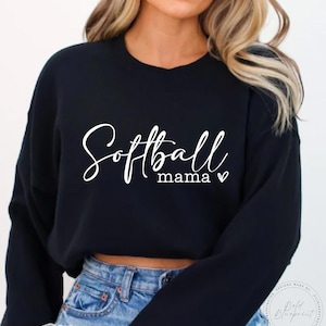 May include: Black cropped sweatshirt with the text "Softball mama" in white cursive lettering with a small heart symbol.