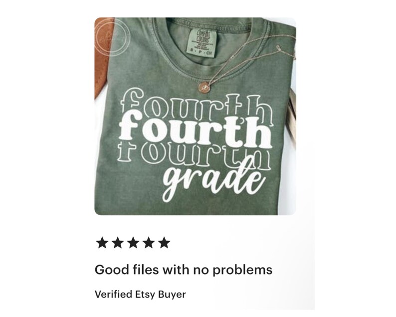 May include: A green t-shirt with the words "Fourth Grade" in a stacked, white font. The shirt has a crew neck and a small tag at the neckline. A gold necklace with a pendant is draped on the shirt.