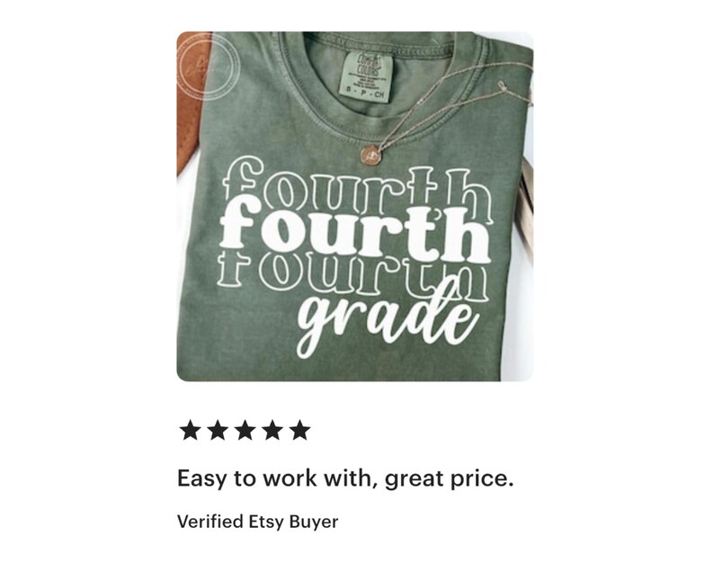 May include: Olive green t-shirt with the words "fourth grade" in a stacked, white, retro font. A gold necklace with a pendant rests on the shirt. The shirt is folded and displayed on a white surface.