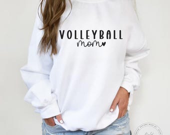 May include: White sweatshirt with the text "Volleyball mom" in black lettering with a small heart.