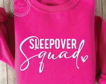 May include: A bright pink sweatshirt with the text "Sleepover Squad" in white lettering with a small white heart.