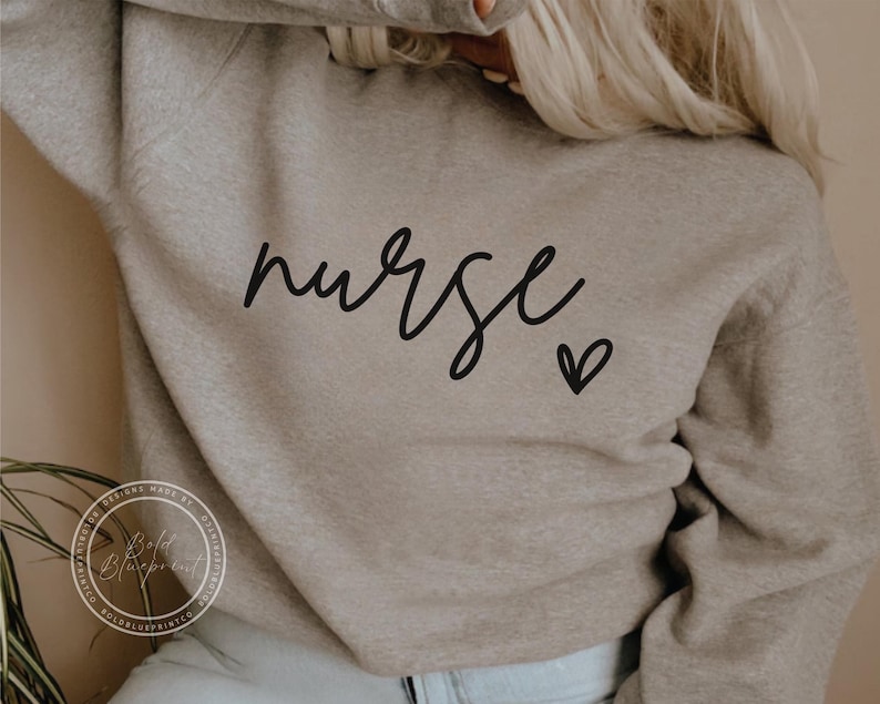 Peut inclure: Un sweat-shirt gris avec le mot "nurse" &eacute;crit en cursive noire et un petit c&oelig;ur noir.