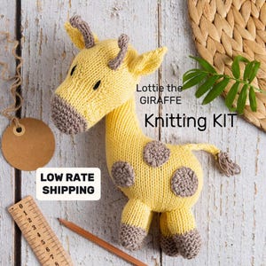 May include: Knitting kit for a yellow and brown giraffe stuffed animal named Lottie. The kit includes yarn and instructions to knit the giraffe.