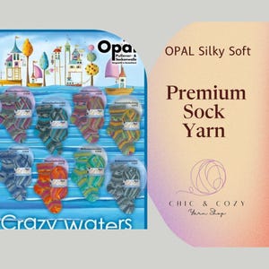 May include: A colorful display of Opal Silky Soft premium sock yarn in various colorways. The yarn is displayed on a blue background with a whimsical illustration of a town on a lake. The text "Crazy Waters" is at the bottom of the display. The text "OPAL Silky Soft Premium Sock Yarn" is displayed in a pink and orange gradient background. The text "CHIC & COZY Yarn Shop" is displayed in a circle with a pink and orange gradient background.