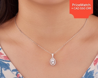 May include: A silver chain necklace with a small oval pendant featuring a clear stone surrounded by smaller stones.