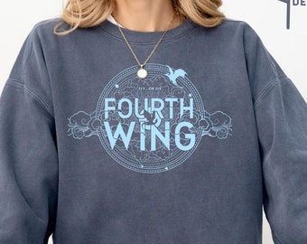 May include: A blue sweatshirt with a light blue graphic design featuring a circle with the text "Fly or Die" and "Fourth Wing" inside. The graphic also includes a stylized bird and clouds.