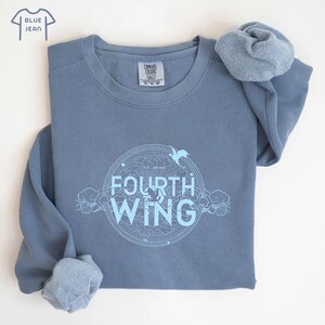 May include: A blue sweatshirt with a white graphic design that says "Fly or Die Fourth Wing" in a circle with a bird design.