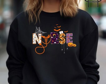 May include: Black sweatshirt with the word "NURSE" in a Halloween-themed design. The letters are decorated with bats, pumpkins, a spider web, and medical symbols. The sweatshirt is a crew neck style.