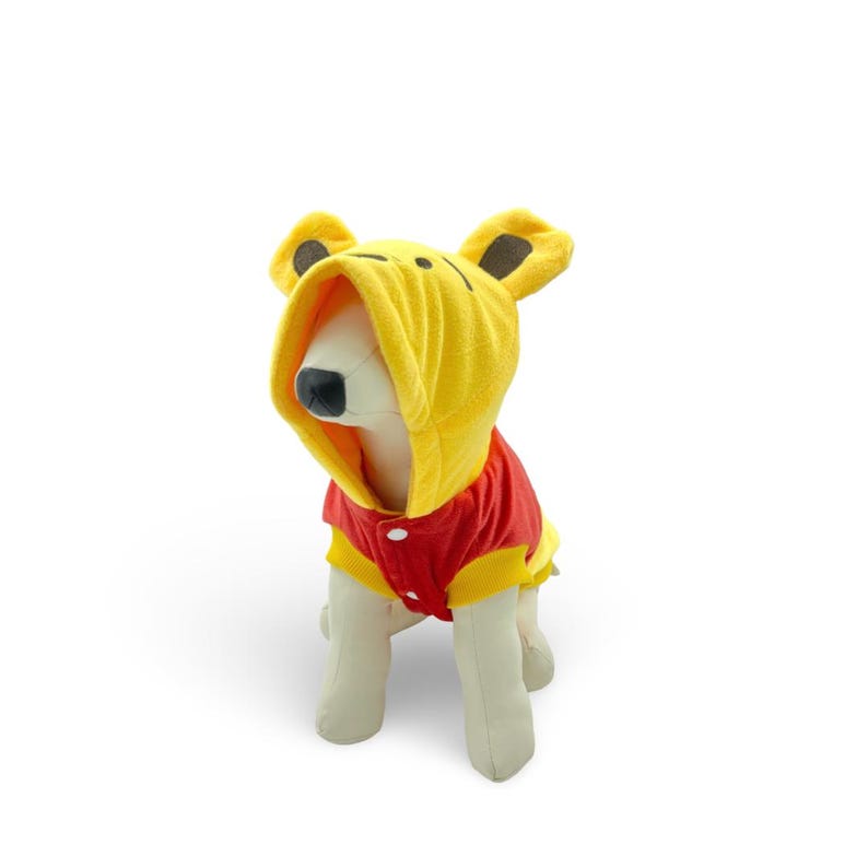 May include: A yellow and red dog costume with a hood. The costume is designed to look like Winnie the Pooh. The costume is on a white mannequin.