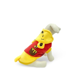 May include: Red and yellow dog hoodie with a cartoon bee and honey pot design. The hoodie has a hood with ears.