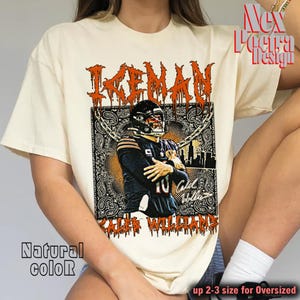 May include: Cream-colored t-shirt featuring a graphic of a football player in a black and orange uniform. The design includes the name "KEVAN" in orange, a paisley pattern, and the text "CALEB WILLIAMS". The shirt also has the text "Natural color".
