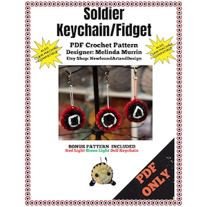 May include: A crochet pattern for a red, white, and black soldier keychain or fidget toy. The pattern includes a bonus pattern for a red light green light doll keychain. The pattern is available as a PDF download only.