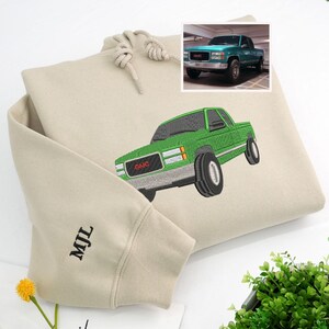 Sand embroidered hoodie featuring custom green GMC pickup truck design inspired by real photo, with initials “MJL” on sleeve. Personalized embroidered truck sweatshirt for classic car owners and car enthusiasts.