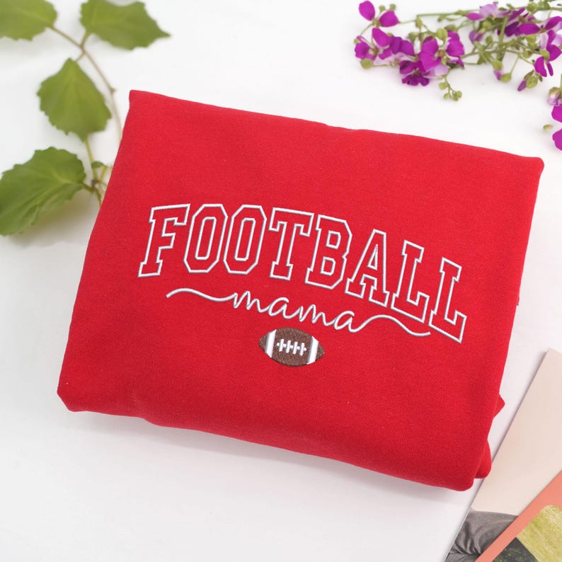 Custom embroidered Football Mama sweatshirt in Red, featuring bold varsity lettering with football design. Cozy cotton-poly blend for comfort and durability. Perfect game day outfit, thoughtful gift for football moms, or team spirit wear. Handmade embroidery adds a premium, durable, one-of-a-kind touch. Available in multiple sizes and colors