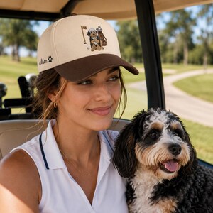 Close-up of a happy woman wearing a detailed "GOLF DOG" golf hat. This fun and stylish accessory is the perfect dog golf lover gift, capturing the fun spirit of the game. Expertly crafted, this golf hat offers both sun protection and a trendy look, making it a great addition to any golfer’s gear collection. It is a thoughtful gift that perfectly bridges the gap between a love for golf and a special bond with their pup.