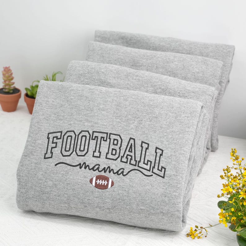 Custom embroidered Football Mama sweatshirt in Sport Grey, featuring bold varsity lettering with a football design. Cozy cotton-poly blend for everyday wear. Perfect gift for football moms, game day outfits, or supporting your player from the stands. Handmade embroidery adds a premium, durable, one-of-a-kind touch. Available in multiple sizes and colors