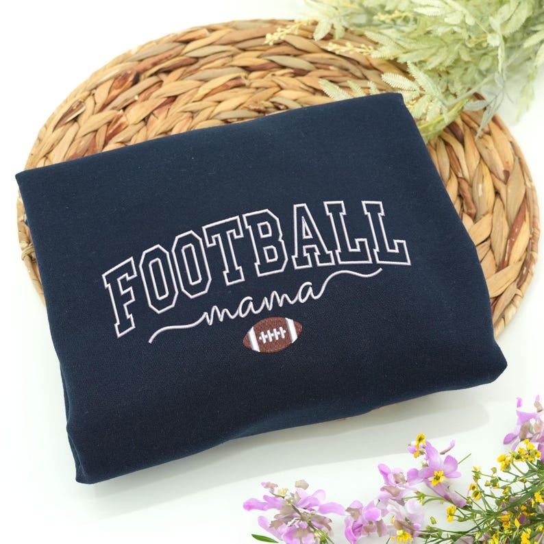 Custom embroidered Football Mama sweatshirt in Navy, featuring varsity lettering with football design. Soft cotton-poly blend, cozy and durable for everyday wear. Perfect gift for football moms, game day outfits, or showing team pride. Handmade embroidery adds a premium, long-lasting, one-of-a-kind touch. Available in multiple sizes and colors