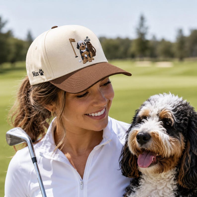 A woman holding a golf club, wearing a fun and stylish "GOLF DOG" embroidered golf hat. This unique cap is the ideal dog golf lover gift, perfect for golf enthusiasts who want to express their personality on the course. Designed to provide shade and comfort throughout your game, this golf hat is a functional accessory that makes a thoughtful gift for any woman who loves golf, dogs, and showing off her unique sense of style.