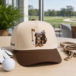 A high-quality navy blue golf hat featuring a unique, detailed embroidery of a cool dog wearing sunglasses and golf gear. This trendy cap is the ultimate dog golf lover gift for any golfer who adores their canine companion. With a perfect blend of humor and style, this embroidered golf cap is a standout accessory for the course, making it a thoughtful and fun gift for dog dads and golf enthusiasts alike.