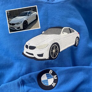 Royal embroidered sweatshirt featuring custom white BMW car embroidery inspired by owner’s photo, with BMW logo patch on sleeve. Unique personalized car sweatshirt for BMW fans and car enthusiasts.