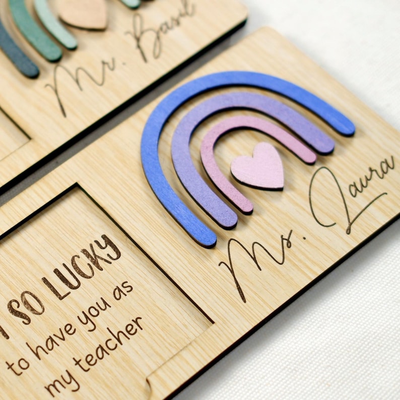 May include: Wooden sign with a rainbow design and the text "I SO LUCKY to have you as my teacher" and "Mrs. Laura".