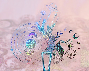 May include: A set of iridescent holographic stickers featuring celestial and mystical designs. The stickers include a sun, moon, stars, a hand with a crystal, a bottle with a floral design, and a crescent moon.