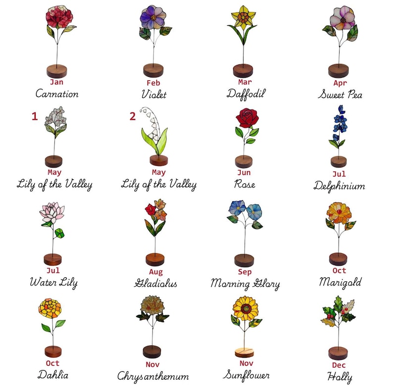 May include: A collection of sixteen stained glass flower ornaments, each mounted on a small circular wooden base. The flowers represent months of the year, labelled with names like Carnation, Violet, Daffodil, Rose, and Sunflower in black text.