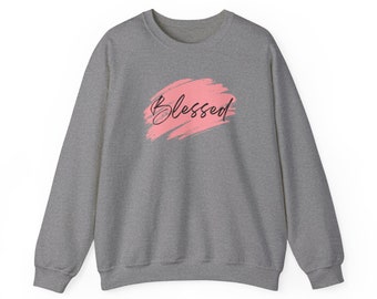 May include: A gray sweatshirt with a pink brushstroke design and the word "Blessed" in black lettering.