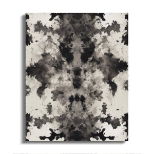 May include: Abstract art print featuring a symmetrical design of black and gray ink splatters on a white background.